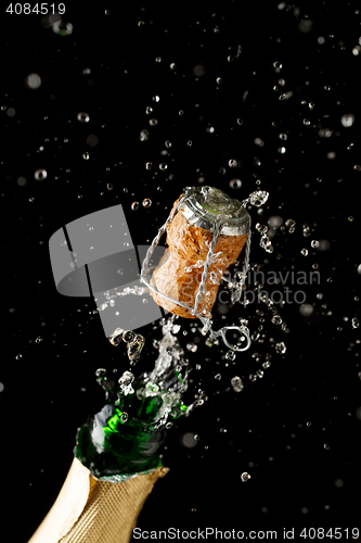 Image of Opening bottle of champagne on empty black background