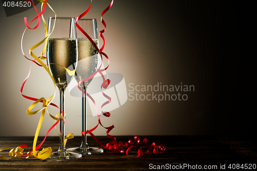 Image of Two glasses with sparkling champagne and festive decoration