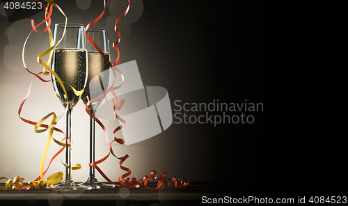 Image of Two glasses with sparkling champagne and decorative ribbons
