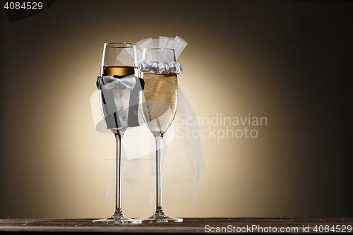 Image of Dressed in wedding suits glasses of champagne