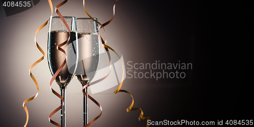 Image of Two glasses filled with champagne ready to party