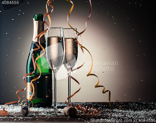 Image of Festive composition with open bottle of champagne and filled glasses