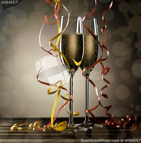 Image of Sparkling champagne in glasses with festive serpentine