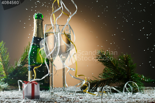 Image of Glasses of champagne, fir-tree branches and gift, festive theme