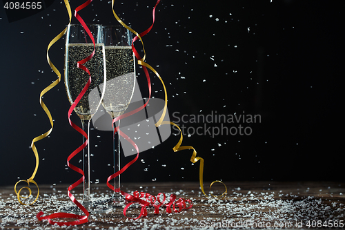 Image of Two glasses of fizzy champagne with beautiful ribbons and snow