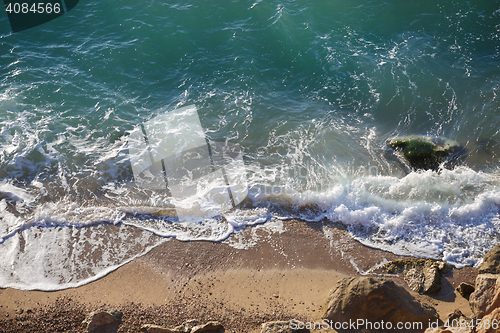 Image of Coastal landscape with sea waves and large boulders on beach