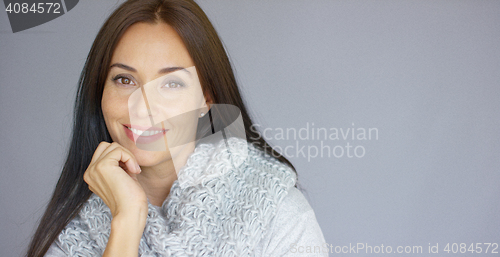Image of Elegant middle aged woman posing with woolen warm scarf