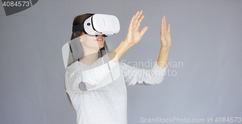 Image of Adorable woman working with virtual reality glasses