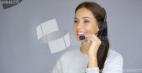 Image of Beautiful and positive female call center agent at work
