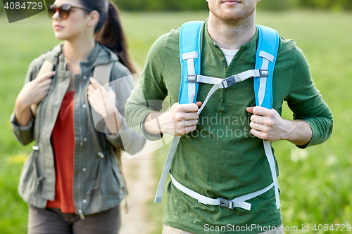 Image of close up of couple with backpacks hiking outdoors