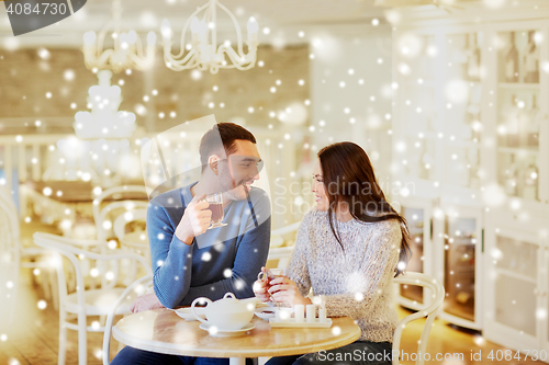 Image of happy couple drinking tea at cafe