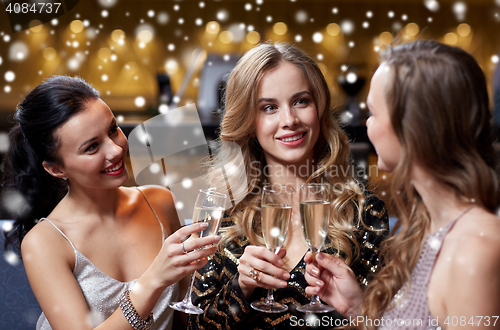 Image of happy women with champagne glasses at night club