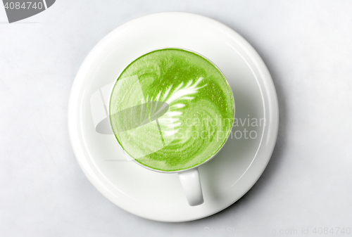 Image of cup of matcha green tea latte over white