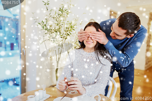 Image of happy couple drinking tea at cafe