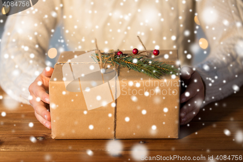 Image of close up of woman with christmas gift or parcel