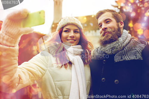 Image of couple taking selfie with smartphone in old town