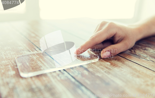 Image of close up of woman with transparent smartphone