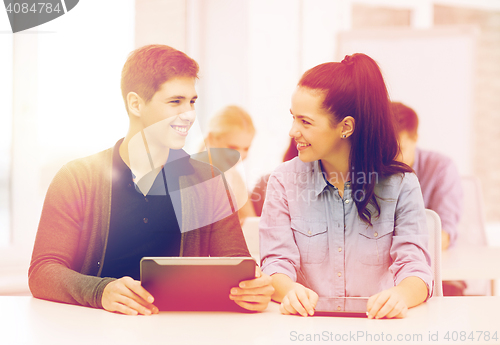 Image of students looking at tablet pc in lecture at school