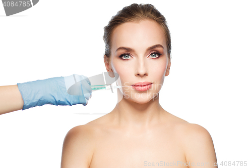 Image of woman face and hand with syringe making injection