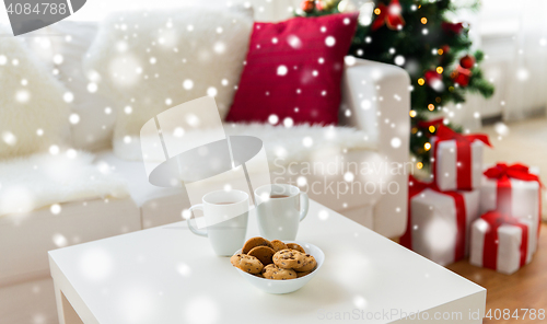 Image of close up of christmas cookies and cups on table