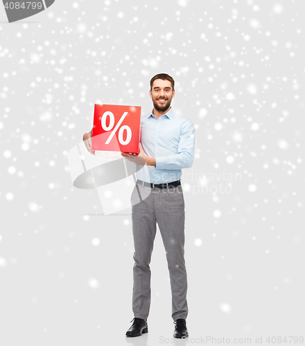 Image of smiling man with red percentage sign over snow