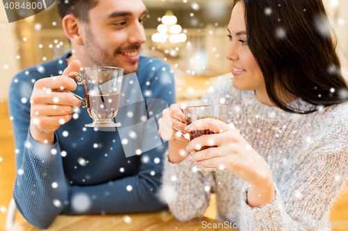 Image of happy couple drinking tea at cafe