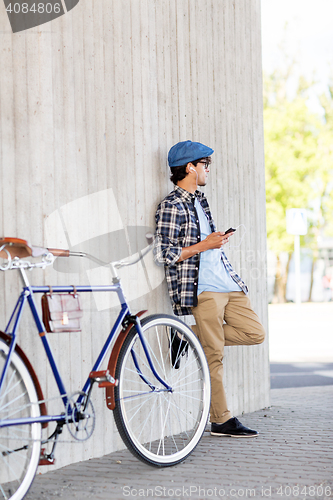 Image of man with smartphone, earphones and bicycle