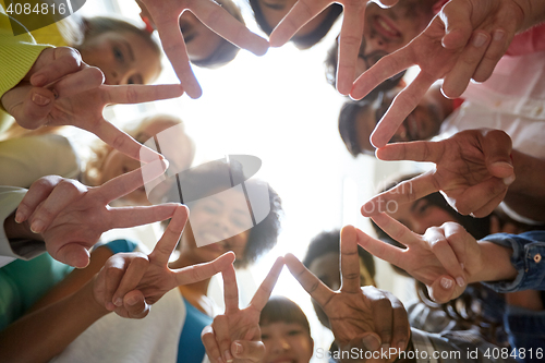 Image of international students showing peace or v sign