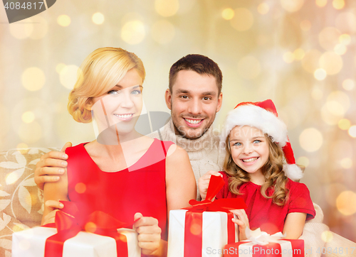 Image of smiling family holding many gift boxes