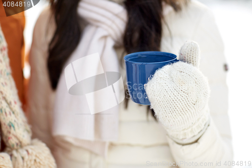 Image of close up of woman holding hot tea cup