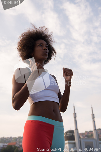 Image of Portrait of sporty young african american woman running outdoors