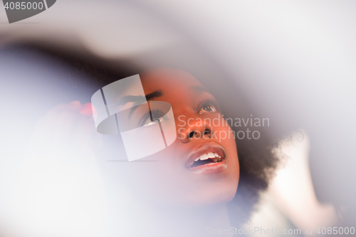 Image of a young African-American woman makeup in the car