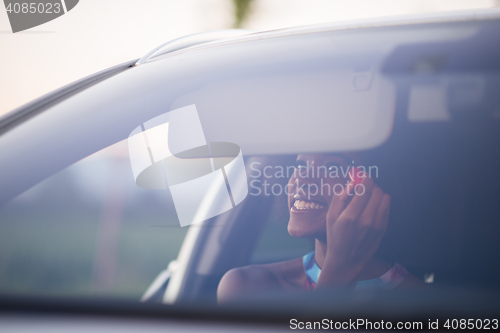 Image of woman making makeup while driving car