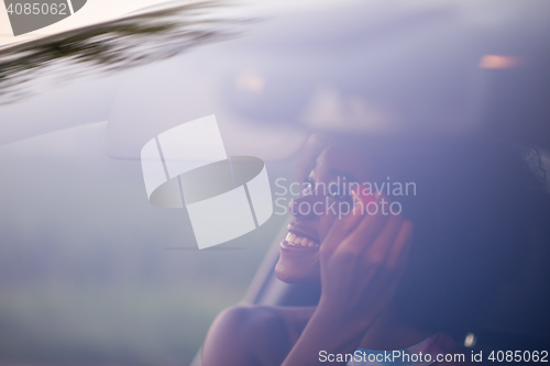 Image of a young African-American woman makeup in the car