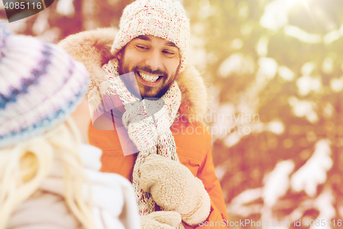 Image of happy friends or couple in winter forest