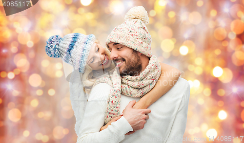 Image of smiling couple in winter clothes hugging