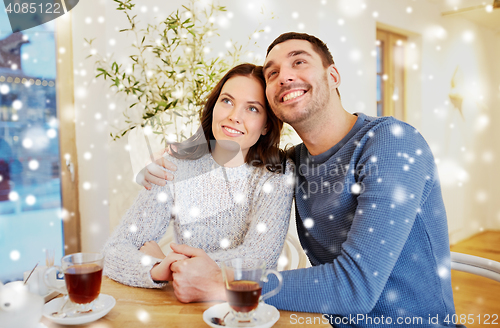 Image of happy couple drinking tea at restaurant