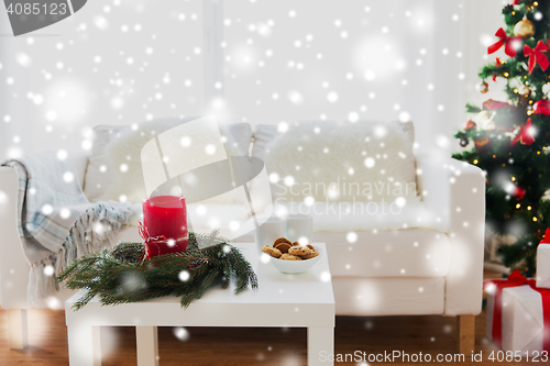 Image of sofa, table and christmas tree with gifts at home