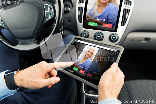 Image of close up of man with tablet pc in car