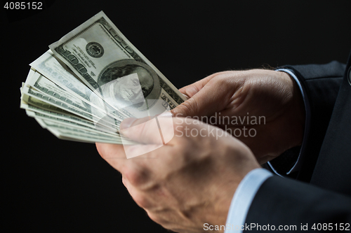 Image of close up of businessman hands holding money