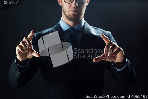 Image of close up of businessman touching virtual screen