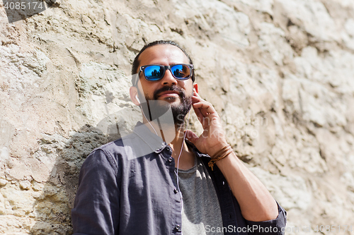 Image of happy man with earphones listening to music