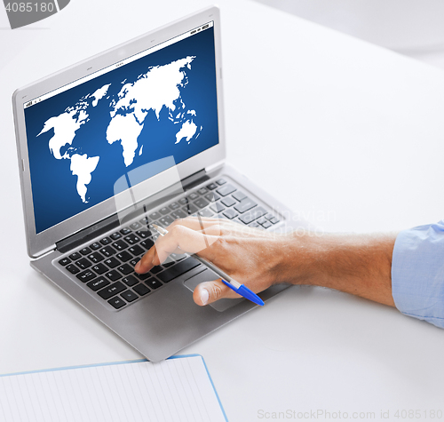 Image of businessman with laptop computer working at office