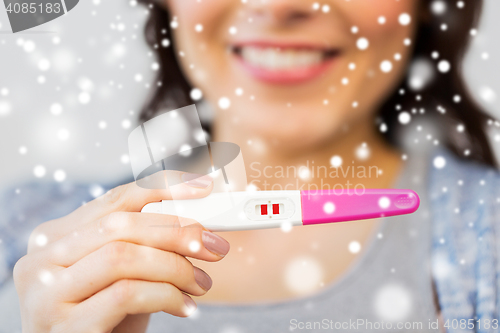 Image of close up of happy woman with home pregnancy test