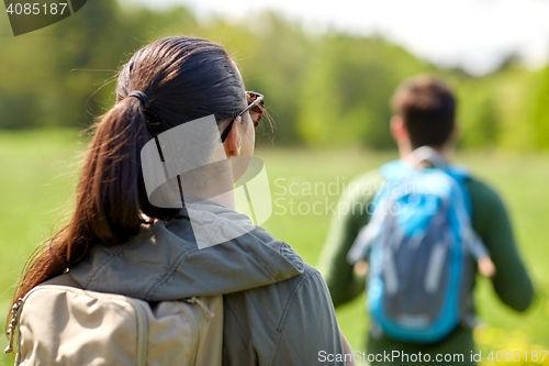 Image of close up of couple with backpacks hiking outdoors