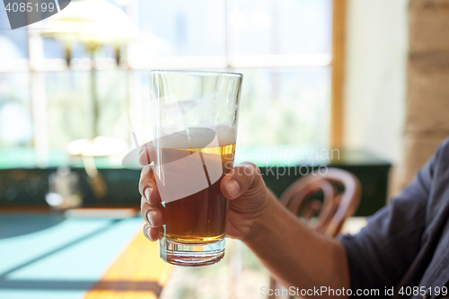 Image of close up of man drinking beer at bar or pub