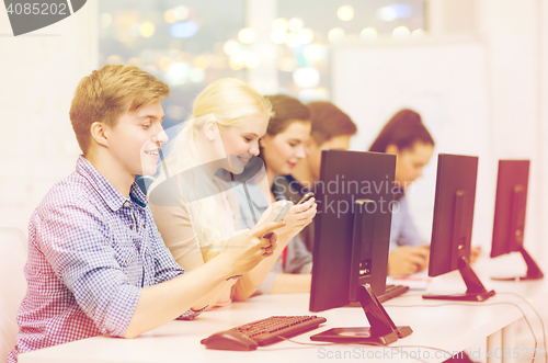 Image of students with computer monitor and smartphones