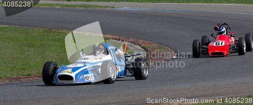 Image of Two old race cars turning