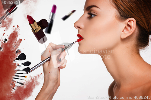 Image of Beautiful female lips with make-up and brush