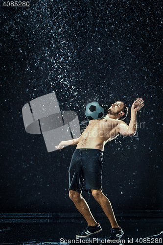 Image of Water drops around football player